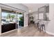 Bright living room featuring a sliding glass door to a covered patio and a modern bar with seating at 2869 Hickory Ridge Dr, Lakeland, FL 33813