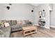 Cozy living room featuring stylish decor, soft gray sofa, wood-look flooring, and ample space for relaxing at 2869 Hickory Ridge Dr, Lakeland, FL 33813