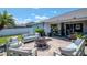 Inviting patio featuring a fire pit, outdoor seating, and lush greenery for a relaxing atmosphere at 2869 Hickory Ridge Dr, Lakeland, FL 33813