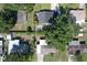 Aerial view of a residential neighborhood and backyard with large trees at 1818 Fredricksburg Ave, Lakeland, FL 33803