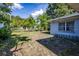 The fenced backyard features mature trees for shade at 1818 Fredricksburg Ave, Lakeland, FL 33803