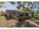 Backyard featuring a retaining wall, various plants, an AC unit, and a grill at 1818 Fredricksburg Ave, Lakeland, FL 33803