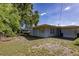 This backyard has a utility door and mature shade trees at 1818 Fredricksburg Ave, Lakeland, FL 33803