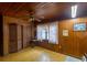 This bedroom features wood paneled walls, ceiling fan, and closet space at 1818 Fredricksburg Ave, Lakeland, FL 33803