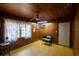 Spacious bedroom with wood paneling, ceiling fan, and a comfortable atmosphere at 1818 Fredricksburg Ave, Lakeland, FL 33803