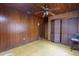 Comfortable bedroom with wood walls, ceiling fan, and closet space at 1818 Fredricksburg Ave, Lakeland, FL 33803