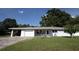 Charming single story home with a two car garage and a well maintained lawn at 1818 Fredricksburg Ave, Lakeland, FL 33803