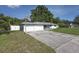 Single story home with a two car garage and a basketball hoop in the front yard at 1818 Fredricksburg Ave, Lakeland, FL 33803