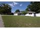 This single-story home has a large front yard and mature shade tree at 1818 Fredricksburg Ave, Lakeland, FL 33803