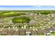 Aerial view showcases a community of homes surrounding a picturesque pond with lush landscaping at 2175 Old Mining Rd, Lakeland, FL 33801