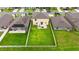 Aerial view of a home with a spacious backyard featuring a patio set, green lawn, and white fence at 2175 Old Mining Rd, Lakeland, FL 33801