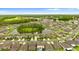 Aerial view showcases a community of homes surrounding a picturesque pond with lush landscaping at 2175 Old Mining Rd, Lakeland, FL 33801