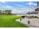 Large backyard, a patio with a grill and seating, and a scenic view beyond the fence at 2175 Old Mining Rd, Lakeland, FL 33801