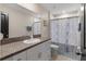 Updated bathroom features granite countertops, white cabinetry and stylish shower curtain at 2175 Old Mining Rd, Lakeland, FL 33801
