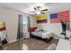 Comfortable bedroom with flags, a ceiling fan, and lots of natural light streaming from the window at 2175 Old Mining Rd, Lakeland, FL 33801