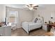 This charming bedroom features a ceiling fan, wood-look floors, and plenty of natural light at 2175 Old Mining Rd, Lakeland, FL 33801