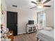 This bedroom has wood-look floors and a modern black door for a striking contrast at 2175 Old Mining Rd, Lakeland, FL 33801