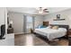 Comfortable bedroom with laminate floors, ceiling fan, and abundant natural light at 2175 Old Mining Rd, Lakeland, FL 33801