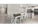 Bright dining room with dark wood table, six white chairs and modern light fixture at 2175 Old Mining Rd, Lakeland, FL 33801