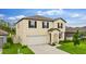 Attractive two-story home with a well-kept lawn and attached two-car garage at 2175 Old Mining Rd, Lakeland, FL 33801