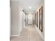 Inviting hallway featuring neutral paint, tile floors, and sliding barn doors at 2175 Old Mining Rd, Lakeland, FL 33801