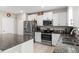 Modern kitchen with stainless steel appliances, granite countertops, and ample white cabinetry at 2175 Old Mining Rd, Lakeland, FL 33801