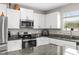 Bright kitchen featuring stainless steel appliances, granite countertops, and ample white cabinetry at 2175 Old Mining Rd, Lakeland, FL 33801