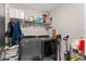 This practical laundry room features a washer, dryer, storage shelves and cleaning supplies at 2175 Old Mining Rd, Lakeland, FL 33801