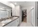 Spa-like bathroom featuring dual sinks, granite counters, and a glass-enclosed shower at 2175 Old Mining Rd, Lakeland, FL 33801