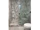 Bathroom featuring a walk-in shower with shelves, toilet and a large window at 225 N Palmetto Ave, Fort Meade, FL 33841