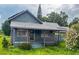 Charming single-story home featuring a covered front porch and mature landscaping at 225 N Palmetto Ave, Fort Meade, FL 33841