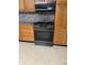 Kitchen appliances with stone countertops and cabinets at 225 N Palmetto Ave, Fort Meade, FL 33841