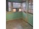 Bright sun room with tile flooring, natural light, and a window AC unit at 225 N Palmetto Ave, Fort Meade, FL 33841