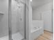 Well-lit bathroom with a glass enclosed shower and a luxurious soaking tub for relaxation at 247 Big Sioux Dr, Poinciana, FL 34759