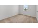 Cozy bedroom with neutral carpet and a window offering natural light and views at 247 Big Sioux Dr, Poinciana, FL 34759