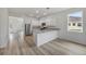 Well-lit kitchen with stainless steel appliances, breakfast bar, granite countertops, and modern cabinetry at 247 Big Sioux Dr, Poinciana, FL 34759