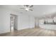 Open floor plan with wood-look flooring, ceiling fan and easy access to the kitchen area at 247 Big Sioux Dr, Poinciana, FL 34759
