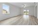 Bright living room featuring neutral wall colors, ample natural light, sliding glass doors, and attractive wood-look flooring at 247 Big Sioux Dr, Poinciana, FL 34759
