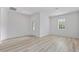 Bright living room featuring neutral wall colors, ample natural light, and attractive wood-look flooring at 247 Big Sioux Dr, Poinciana, FL 34759