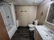 Bathroom featuring a modern vanity, toilet, and tub with white tiling and wood-look flooring at 2777 Cr 673, Bushnell, FL 33513