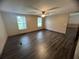Bedroom featuring wood-look floors, a ceiling fan, and two windows, and neutral colored walls at 2777 Cr 673, Bushnell, FL 33513