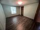 Bedroom with wood-look flooring, a window letting in natural light, and green colored walls at 2777 Cr 673, Bushnell, FL 33513