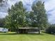 Inviting single-story home surrounded by towering trees, offering a serene and private setting at 2777 Cr 673, Bushnell, FL 33513