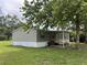 Cozy single-story home with an inviting covered porch and a well-manicured lawn at 2777 Cr 673, Bushnell, FL 33513