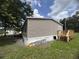 Side view of the home showcasing the siding and the exterior entrance at 2777 Cr 673, Bushnell, FL 33513
