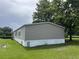 Side view of a well-kept single-story home with neutral siding and a green lawn at 2777 Cr 673, Bushnell, FL 33513