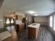 Open kitchen flows into the living room with stainless steel refrigerator and island at 2777 Cr 673, Bushnell, FL 33513