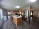 Open kitchen with island and stainless steel appliances, adjoined to the living area at 2777 Cr 673, Bushnell, FL 33513