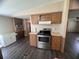 A modern stainless steel oven and cooktop are surrounded by light wood cabinetry and stylish countertops at 2777 Cr 673, Bushnell, FL 33513