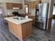 Well-lit kitchen featuring a central island, stainless steel refrigerator, and modern appliances at 2777 Cr 673, Bushnell, FL 33513